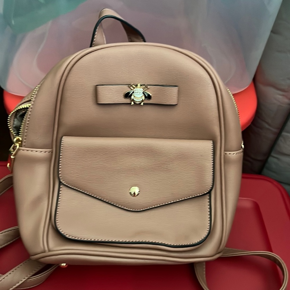 Like new small backpack with bee blush color